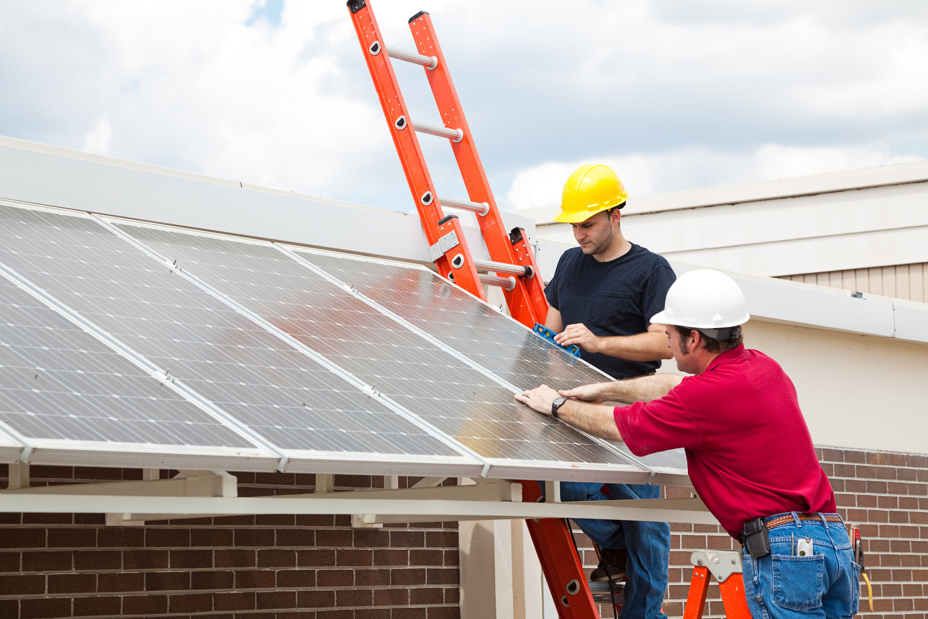 Bauarbeiten an Solaranlage mit zwei Arbeitern